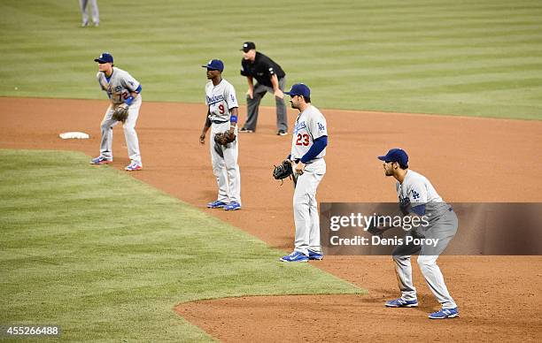 Los Angeles Dodgers players line up using an extreme infield shift as Seth Smith of the San Diego Padres comes up to bat during the twelfth inning of...