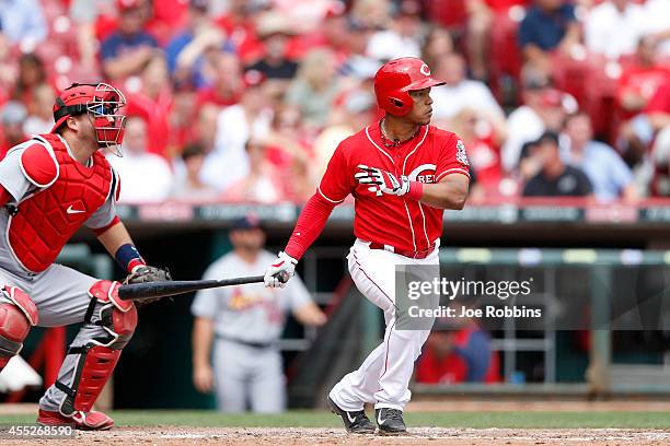 Ramon Santiago of the Cincinnati Reds hits into a fielder's choice to drive in a run in the eighth inning of the game against the the St. Louis...