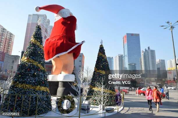 Statue of Santa Claus imitating Marilyn Monroe's famous pose stands in front of a shopping mall on December 11, 2013 in Taiyuan, China. This idea is...