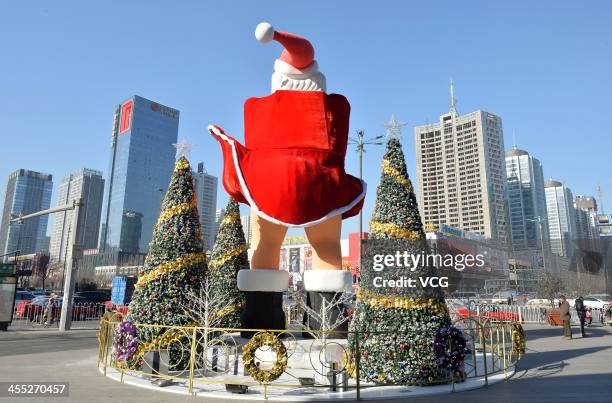 Statue of Santa Claus imitating Marilyn Monroe's famous pose stands in front of a shopping mall on December 11, 2013 in Taiyuan, China. This idea is...