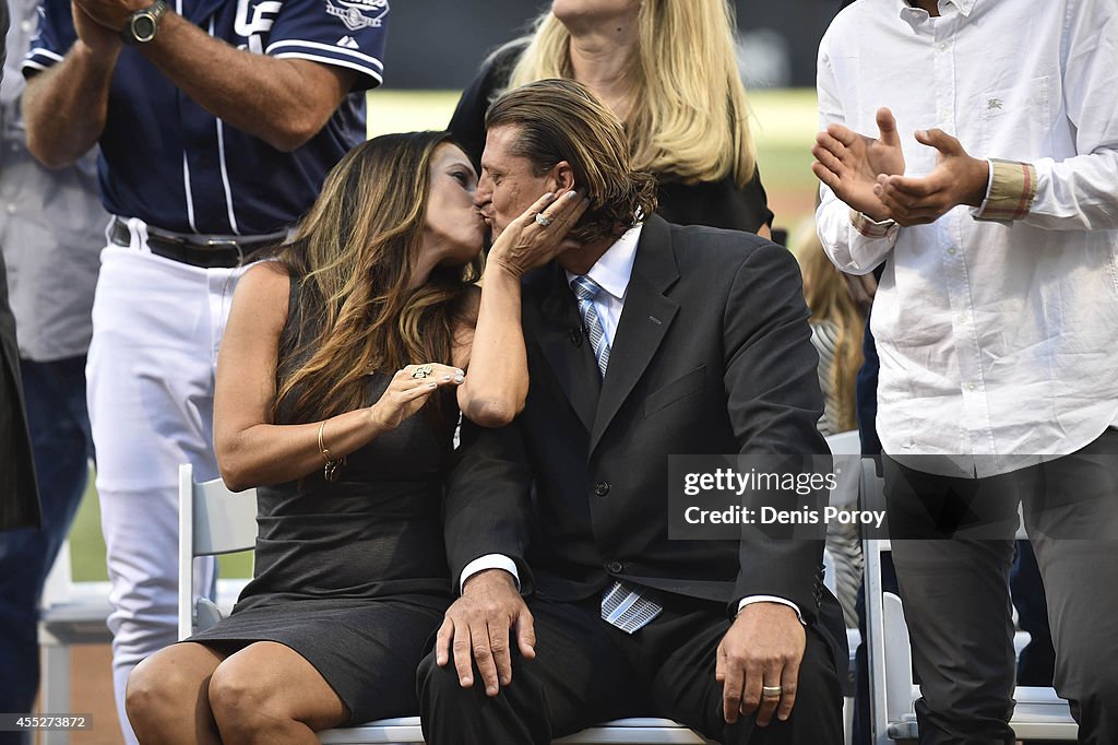 Former San Diego Padres pitcher Trevor Hoffman stands between his wife, Tracy, and one of his sons as he looks at a standing ovation by fans during his induction into the Padres