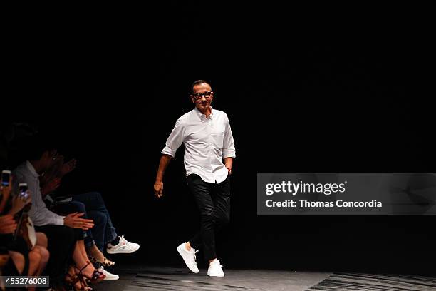 Gilles Mendel greets the audience after presenting the J. Mendel Spring 2015 Collection during Mercedes-Benz Fashion Week Spring 2015 at The Theatre...