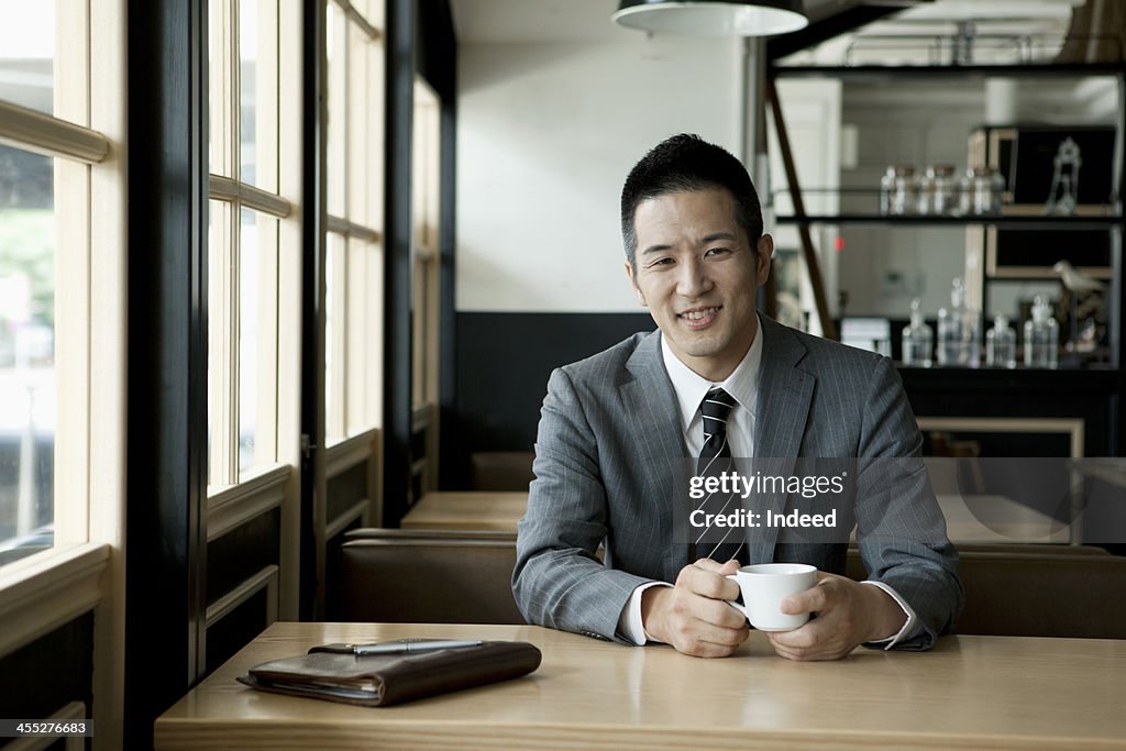 The 30th generation male businessman who drinks coffee