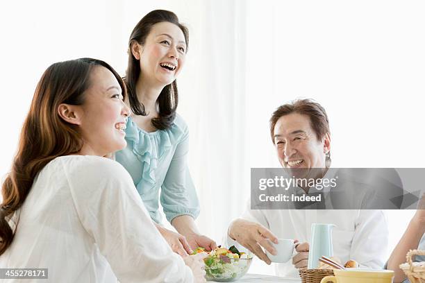 the four-person family surrounding a table - teenagers eating with mum stock pictures, royalty-free photos & images