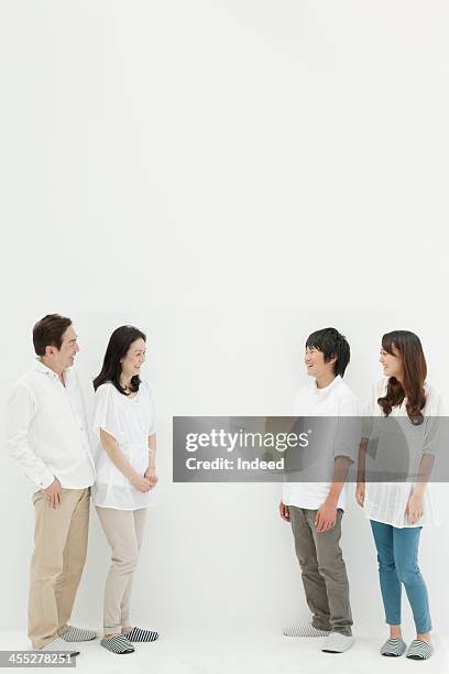 four person family with good relations - family standing stock pictures, royalty-free photos & images