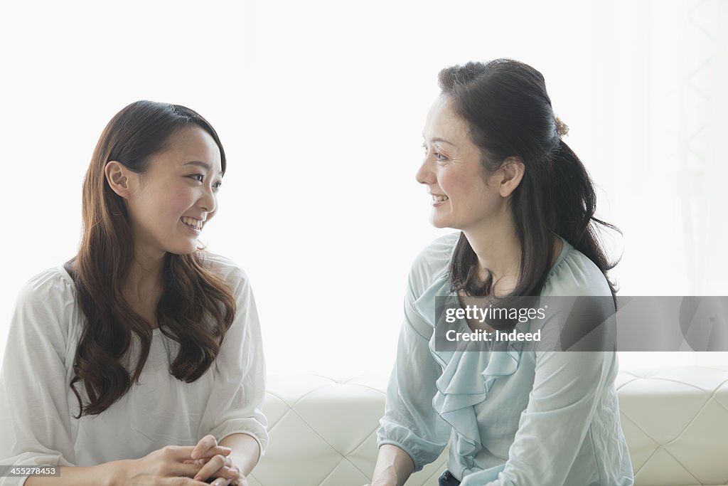 Mother and daughter having a flower