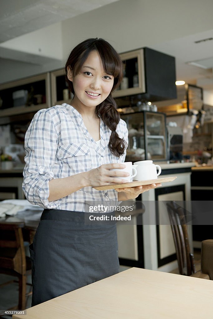 Young female cafe salesclerk