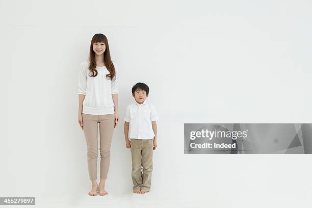 mother and son smile in front of the white background - whole ストックフォトと画像