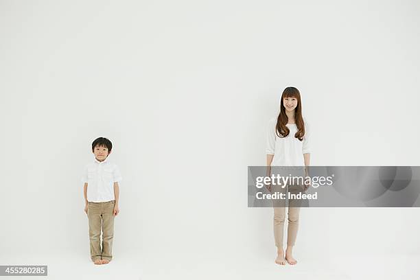 mother and son smile in front of the white background - smile woman child stock-fotos und bilder