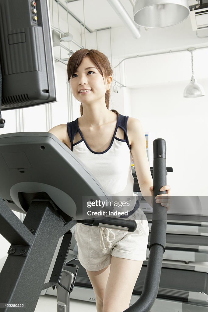 Woman takes exercise in the gym