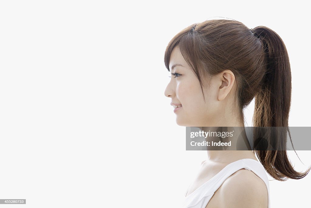 Sideways-facing of woman dressed in tank top