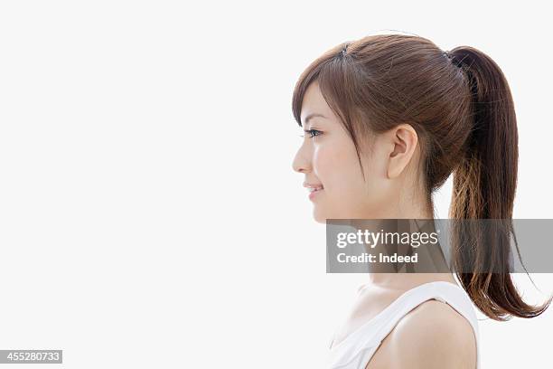 sideways-facing of woman dressed in tank top - ponytail stock pictures, royalty-free photos & images