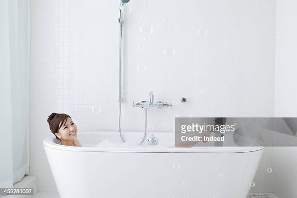 woman takes a bath - japanese women bath stock pictures, royalty-free photos & images