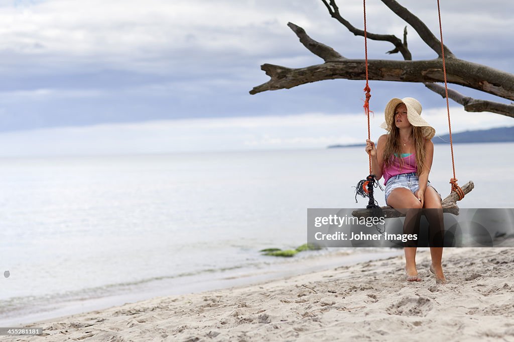 Girl swinging on beach