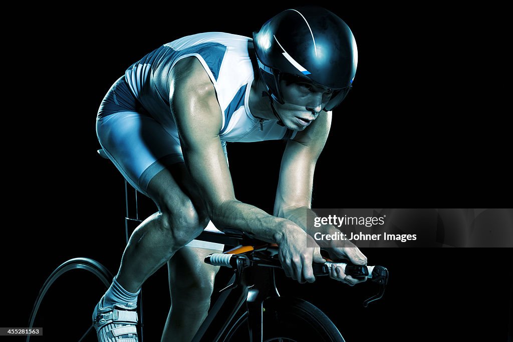 Man cycling, studio shot