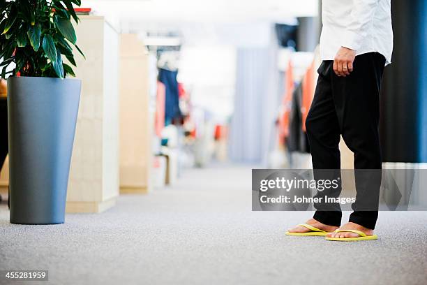 businessman wearing flip-flops, low section - flip flop stock pictures, royalty-free photos & images