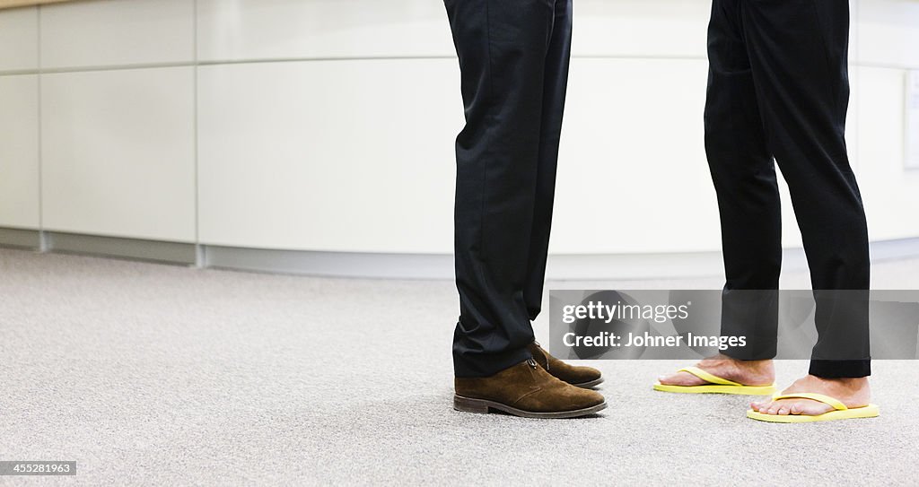 Two businessmen meeting, low section