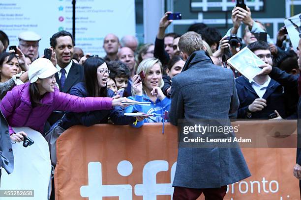 Actor Hayden Christensen signs autograph as he attends the "American Heist" premiere during the 2014 Toronto International Film Festival at Princess...