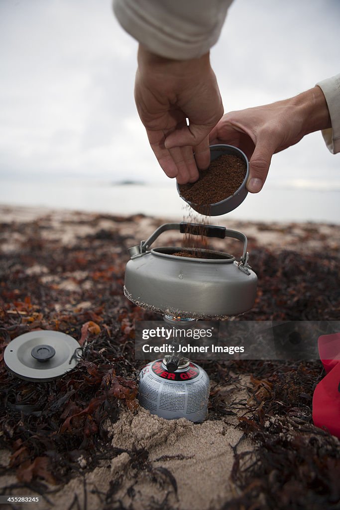 Man preparing coffee in pot