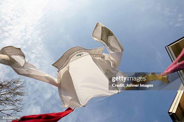 laundry hanging against sky - drying stock pictures, royalty-free photos & images