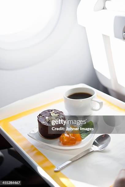 coffee and dessert in airplane - airplane tray stock-fotos und bilder