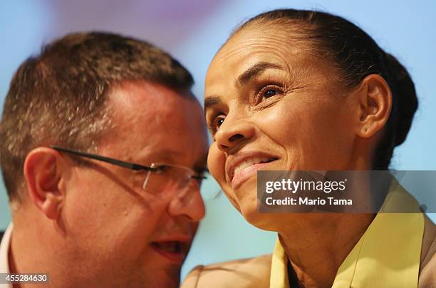 Marina Silva , presidential candidate of the Brazilian Socialist Party, and her running mate, Beto Albuquerque , chat at a campaign event at the...