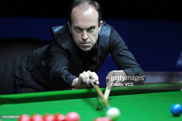 Fergal O'Brien of Ireland plays a shot against Zhao Xintong of China during day four of the World Snooker Bank of Communications OTO Shanghai Masters...