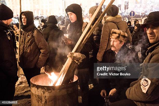 Protesters warming up themselves on Maidan Square on December 11, 2013 in Kiev, Ukraine. Thousands have been protesting against the Ukrainian...
