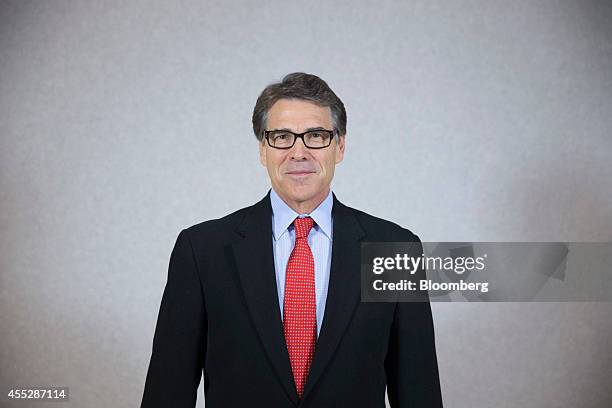 Rick Perry, governor of Texas, poses for a photograph after a Bloomberg Television interview at the World Economic Forum Annual Meeting of the New...