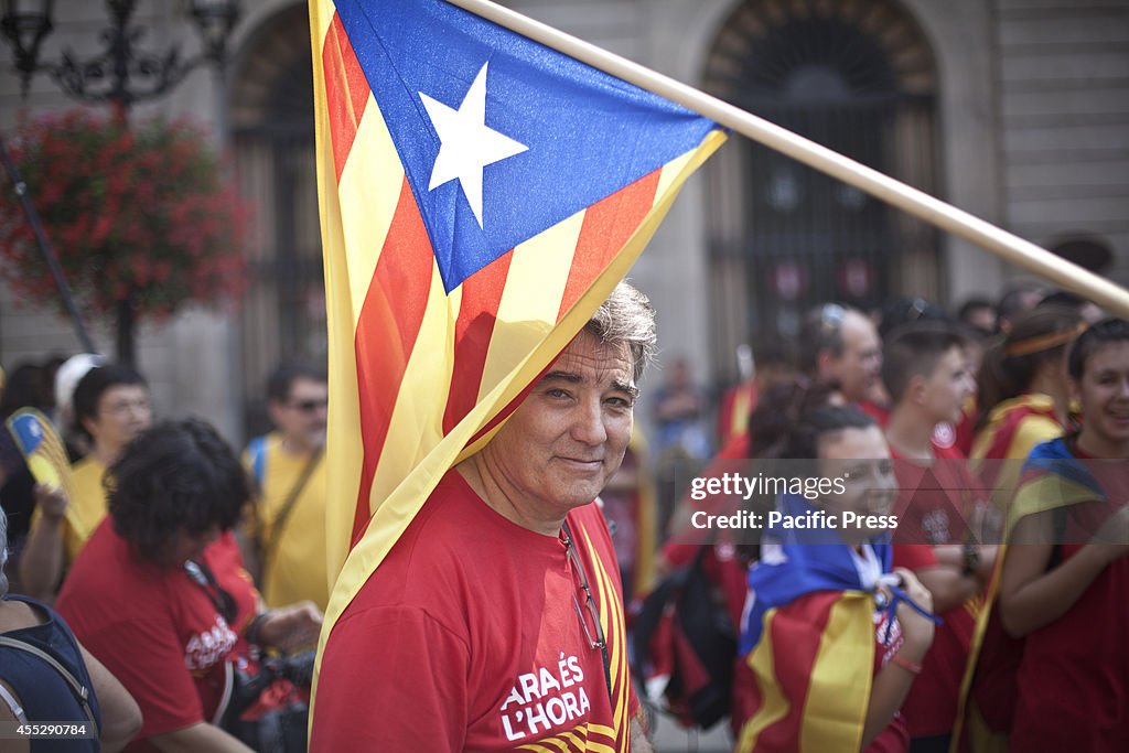 A Pro Catalonia Independence protester under a Catalonian...