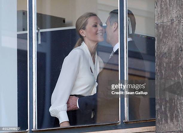 Former German First Lady Bettina Wulff embraces her estranged husband, former German President Christian Wulff, upon her arrival to testify in his...