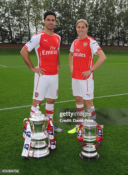 Mikel Arteta of Arsenal and Kelly Smith of Arsenal Ladies during the 1st team squad photograph at London Colney on September 11, 2014 in St Albans,...