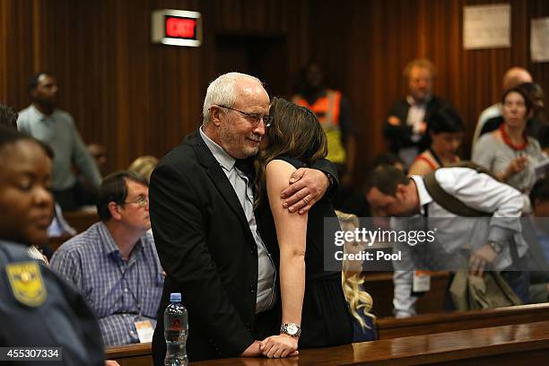 Henke Pistorius hugs his daughter Aimee Pistorius at the Pretoria High Court on September 12 in Pretoria, South Africa. Pistorius, stands accused of...
