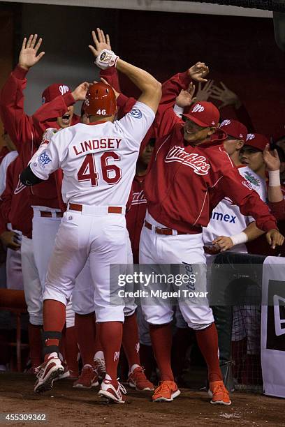 John Lindsey celebrates with teammates after scoring during a match between Pericos de Puebla and Diablos Rojos as part of Serie del Rey Mexican...