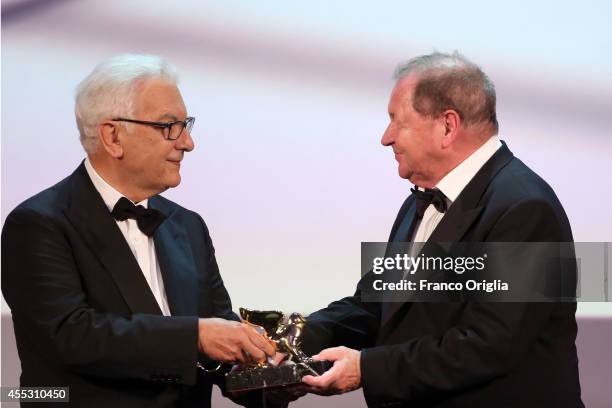Director Roy Andersson poses with the Golden Lion Award for Best Film for 'A Pigeon Sat On A Branch Reflecting On Existence' from the President of...