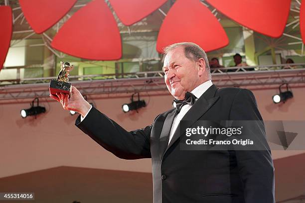Director Roy Andersson poses with the Golden Lion Award for Best Film for 'A Pigeon Sat On A Branch Reflecting On Existence' during the award winners...