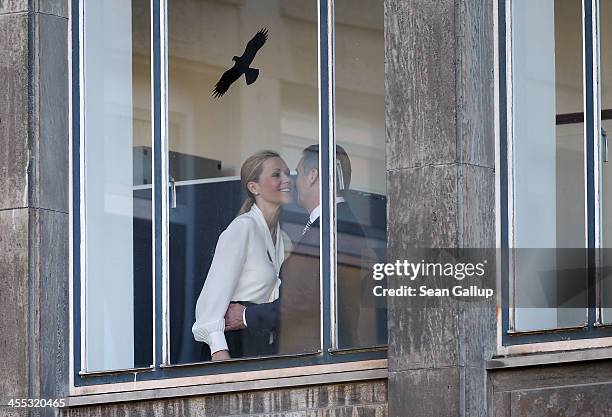 Former German First Lady Bettina Wulff embraces her estranged husband, former German President Christian Wulff, upon her arrival to testify in his...