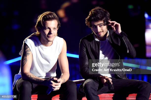 Singers Louis Tomlinson and Zayn Malik of One Direction perform onstage during the One Direction" Where We Are" Tour at Rose Bowl on September 11,...