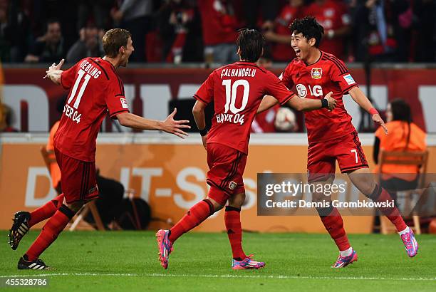 Son Heung-Min of Bayer Leverkusen celebrates with team mates Stephan Kiessling and Hakan Calhanoglu as he scores their thrid goal during the...