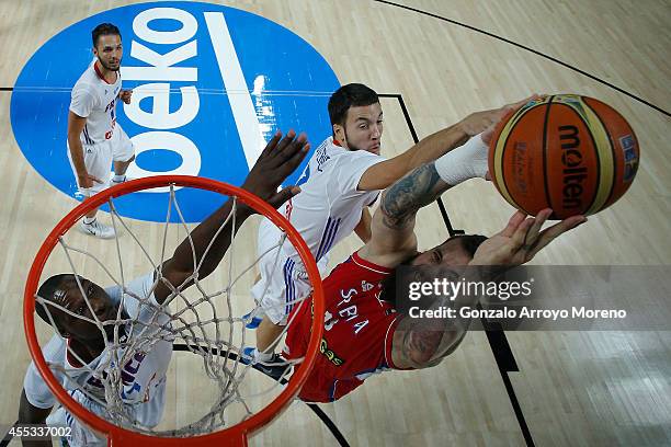 Miroslav Raduljica of Serbia shoots against Joffrey Lauvergne of France and his teammate Mickael Gelabale during the 2014 FIBA World Basketball...