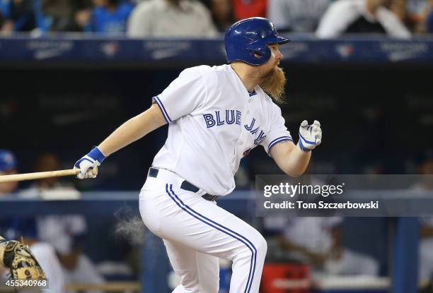 Adam Lind of the Toronto Blue Jays hits a single in the sixth inning during MLB game action against the Tampa Bay Rays on September 12, 2014 at...