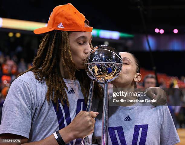 Brittney Griner and Diana Taurasi of the Phoenix Mercury kiss the championship trophy after a win over the Chicago Sky during game three of the WNBA...