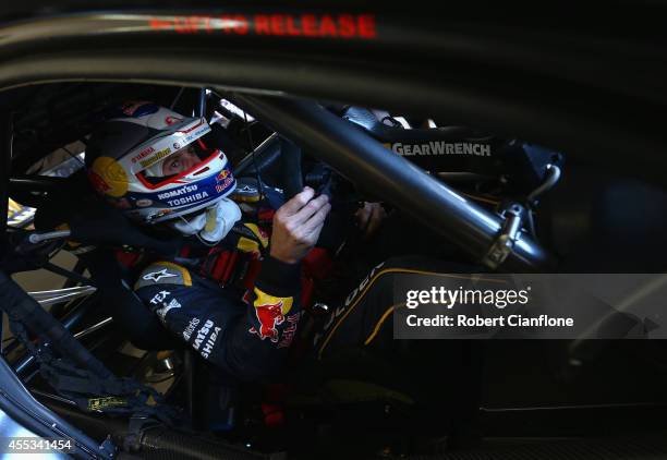 Jamie Whincup driver of the Red Bull Racing Australia Holden sits in his car prior to qualifying for the Sandown 500, which is round ten of the V8...