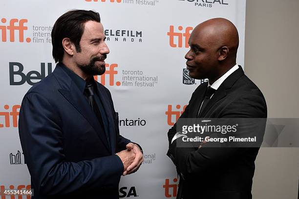 Actor John Travolta and TIFF Artistic Director Cameron Bailey attend "The Forger" premiere during the 2014 Toronto International Film Festival at Roy...