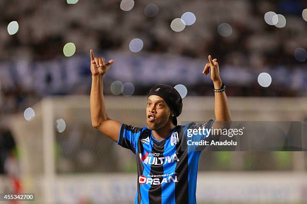 Ronaldinho greets the fans during the football match between Gallos Blancos of Queretaro against Puebla FC of the Liga Bancomer MX at the Corregidora...