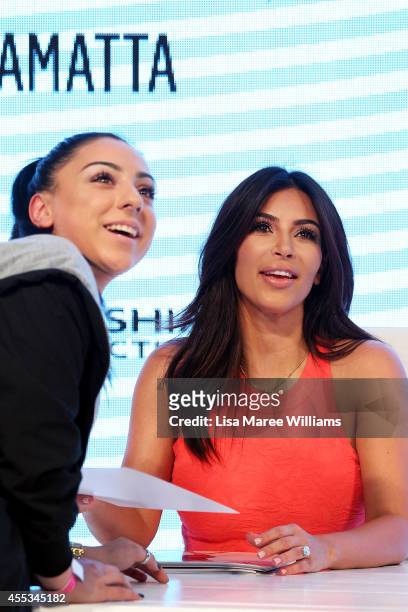 Kim Kardashian greets a fan during the Kardashian Kollection Spring Launch at Westfield Parramatta on September 13, 2014 in Sydney, Australia.