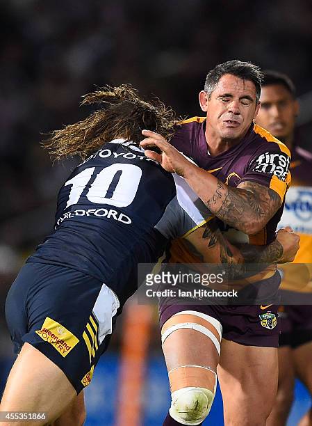 Corey Parker of the Broncos is tackled by Ashton Sims of the Cowboys during the NRL 1st Elimination Final match between the North Queensland Cowboys...