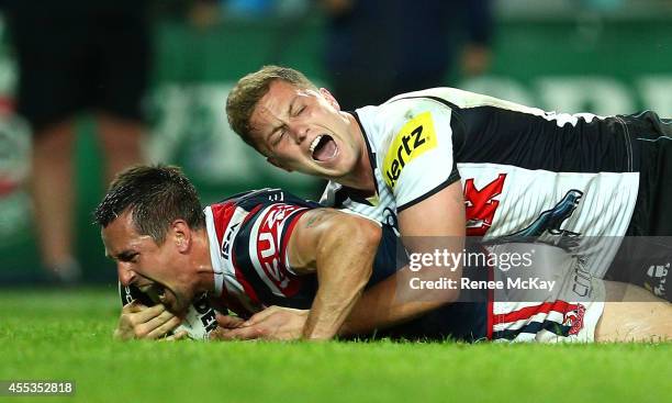 Mitchell Pearce of the Roosters scores a try in the tackle of Matt Moylan during the NRL 1st Qualifying Final match between the Sydney Roosters and...