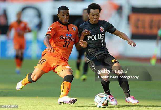 Tsukasas of Urawa Reds and Wellington Daniel Bueno of Shimizu S-Pulse compete for the ball during the J.League match between Shimizu S-Pulse and...