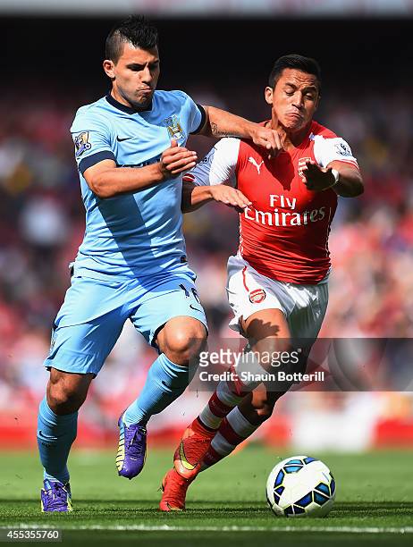 Sergio Aguero of Manchester City and Alexis Sanchez of Arsenal battle for the ball during the Barclays Premier League match between Arsenal and...
